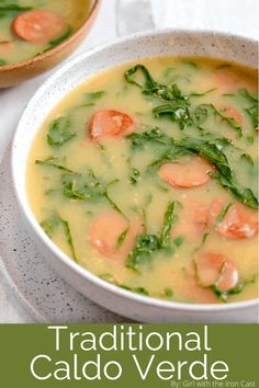 a bowl of soup with carrots and spinach in it