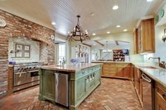 a large kitchen with an island in the middle