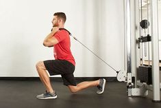 a man is running on a treadmill in the gym with a pull rope attached to his chest