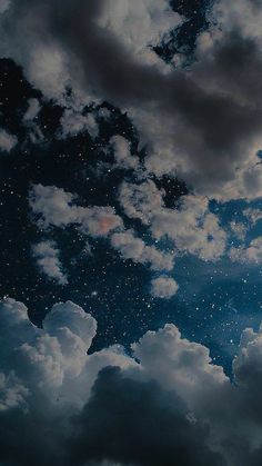 the sky is full of stars and clouds as if they were floating in the air