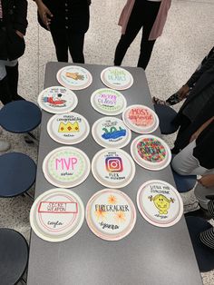 a table topped with lots of plates covered in different types of sticker designs on it