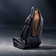 the back end of a black chair with wood in it