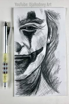 a drawing of a man's face next to a pen