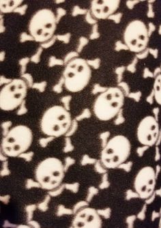 there is a black and white skull pattern on this shirt with skulls all over it