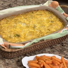 a casserole dish and plate of carrots on a table