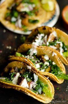 three tacos with lettuce and other toppings