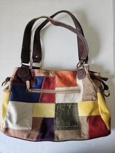 Vintage boho hippie style shoulder bag. Genuine leather, multi color patchwork with shoulder straps. Inside open pockets made for glasses, phone, or accessories. Outside zipper pocket. Gently used, very clean. Two small marks on leather squares shown in pictures, vintage wear on shoulder straps also shown. Multicolor Patchwork Satchel Shoulder Bag, Everyday Patchwork Rectangular Hobo Bag, Everyday Brown Patchwork Shoulder Bag, Multicolor Patchwork Tote Satchel, Multicolor Square Hobo Bag For Travel, Multicolor Square Hobo Bag For Daily Use, Colorful Patchwork Shoulder Bag For Daily Use, Square Multicolor Hobo Bag For Daily Use, Retro Patchwork Shoulder Bag For Everyday Use