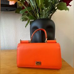 This Dolce & Gabbana Purse Is Like New And In Great Condition. This Purse Comes With A Leather Removable Strap And Original Box. Chic Orange Formal Satchel, Luxury Orange Crossbody Satchel, Formal Orange Shoulder Bag With Detachable Strap, Elegant Orange Bag, Elegant Orange Shoulder Bag For Formal Occasions, Luxury Orange Bags With Top Carry Handle, Elegant Orange Shoulder Bag With Dust Bag, Elegant Orange Shoulder Bag For Evening, Luxury Orange Satchel With Detachable Strap