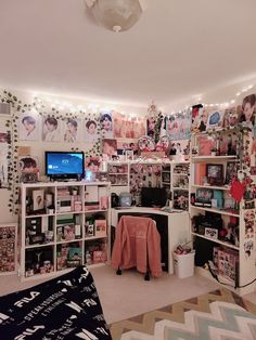 a room filled with lots of shelves and pictures on the wall