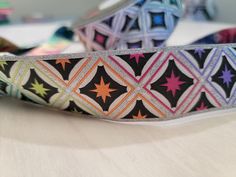 a pair of colorful stars on black and silver grosch ribbon