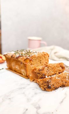 two slices of bread sitting on top of a marble counter next to an apple slice