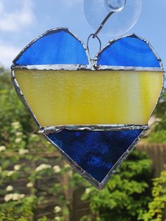 a stained glass heart hanging from a window