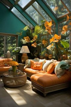 a living room filled with lots of furniture and flowers in the window sills