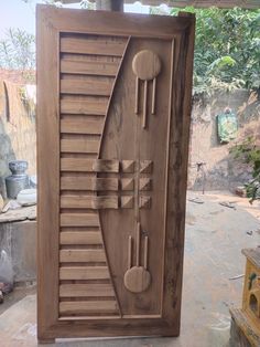 a carved wooden door in the shape of an arrow