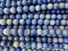 blue and white marble beads stacked on top of each other, with one bead in the middle