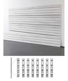 an image of the side of a white wall with five pieces of metal on it