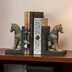 a couple of books are sitting on top of a book shelf next to each other