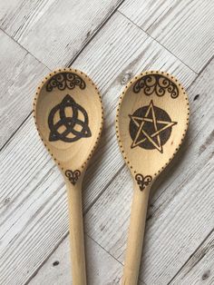 two wooden spoons with designs on them