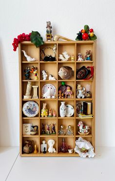 a wooden shelf filled with lots of figurines