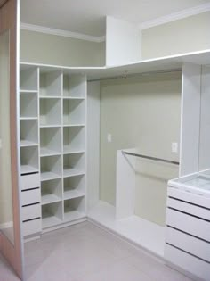 an empty walk in closet with shelves and drawers