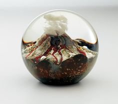 a snow globe with an image of a volcano in it