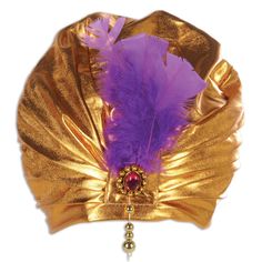 a gold plate with a purple feather on it and a bell hanging from the side