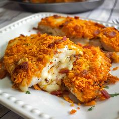 a white plate topped with chicken covered in cheese