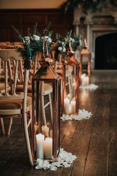 a row of wooden chairs with candles on them