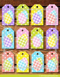 colorful paper tags with polka dots and hearts on them are hanging from a wooden wall