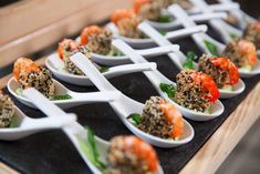 there are many small white bowls with food in them on the tray, ready to be eaten