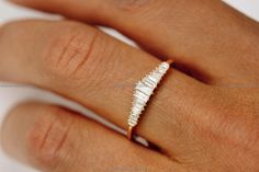 a woman's hand with a diamond ring on top of her finger and the band is in white gold