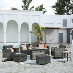 an outdoor seating area with chairs, tables and stools next to a swimming pool