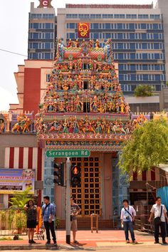 people are standing in front of a colorful building