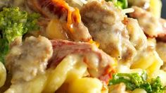 pasta with meat, broccoli and cheese is shown in close up on a plate