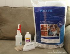 a couch with cleaning supplies on it and a bag of polyfil next to it