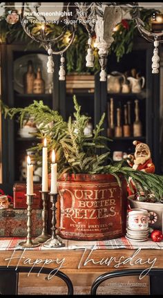 a table topped with candles and christmas decorations