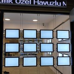 a store front with lots of windows and signs on the glass wall that says link o'zel hauzum