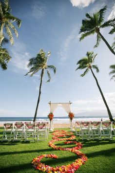 an outdoor wedding setup on the lawn with chairs and flowers in the shape of a heart