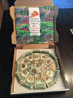 a pizza box with money in it sitting on a table