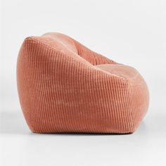 an orange corded chair sitting on top of a white floor