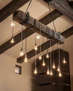 the light bulbs are hanging from the beam in the room, which is decorated with wood beams