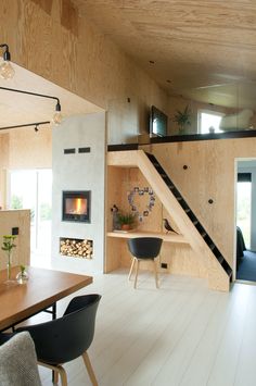 a living room filled with furniture and a fire place in the middle of a room