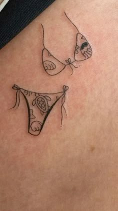 two tattoos on the back of women's butts, one with a bra