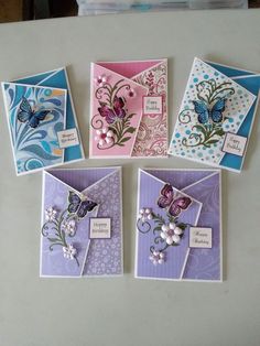 four different cards with butterflies and flowers on them