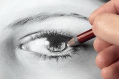 a person is drawing an eye with a pencil