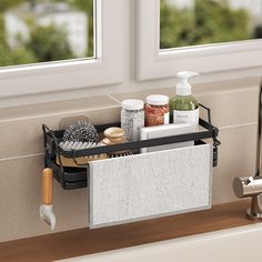 a bathroom sink with soap, lotion and other items in the tray on it