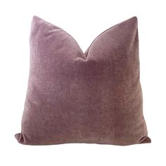 a purple pillow sitting on top of a white wall