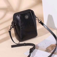 LOW STOCK WARNING Irene Genuine Leather Crossbody Bag is a small-sized bag that is made from genuine leather and cowhide. The bag can fit in things such as your cell phone, wallet, keys, and lip balm. It is perfect for someone who doesn't want to carry too many things with them but still needs the convenience of the it Black Leather Phone Bag For On-the-go, Handheld Leather Phone Bag, Portable Leather Satchel Phone Bag, Leather Phone Bag For Daily Use, Portable Leather Crossbody Phone Bag, Portable Leather Phone Bag For Daily Use, Black Handheld Shoulder Bag With Cell Phone Pocket, Leather Phone Shoulder Bag, Black Leather Portable Phone Bag