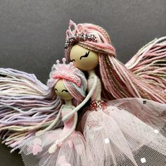 a doll with long hair and a pink dress is sitting on top of a net