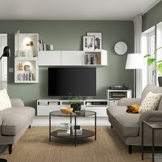 a living room filled with furniture and a flat screen tv